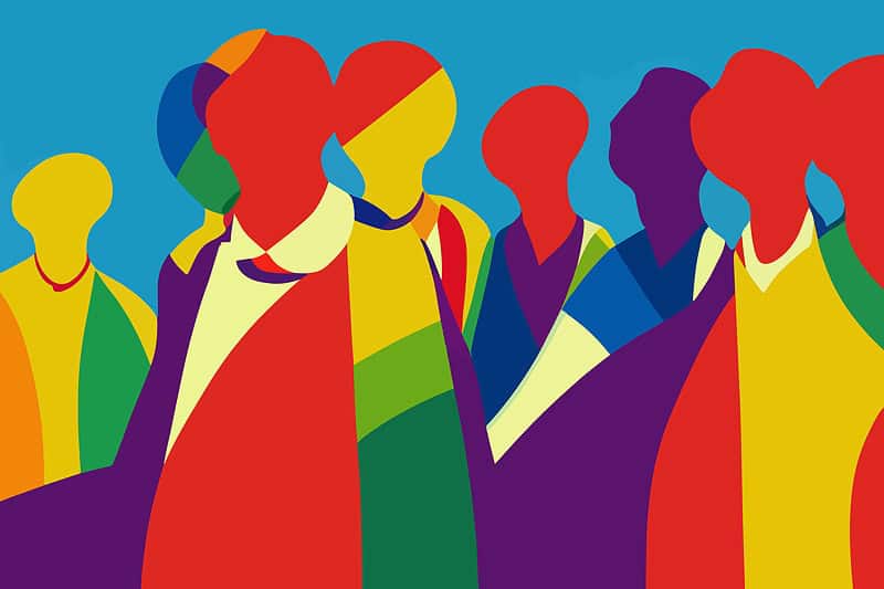 A group of people in colorful clothes standing in front of a blue background.